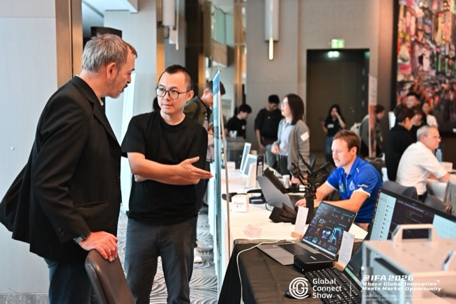 Attendees in conversation at a demo table, GCS @IFA 2026