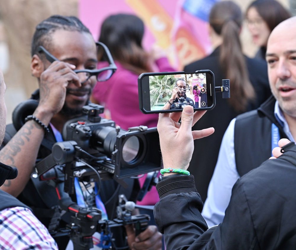 Journalists filming and photographing at a GCS event